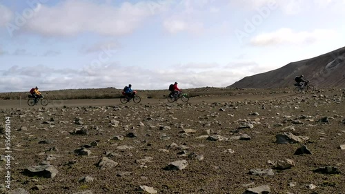 Amazing aerial drone shot of people riding on a path in Iceland