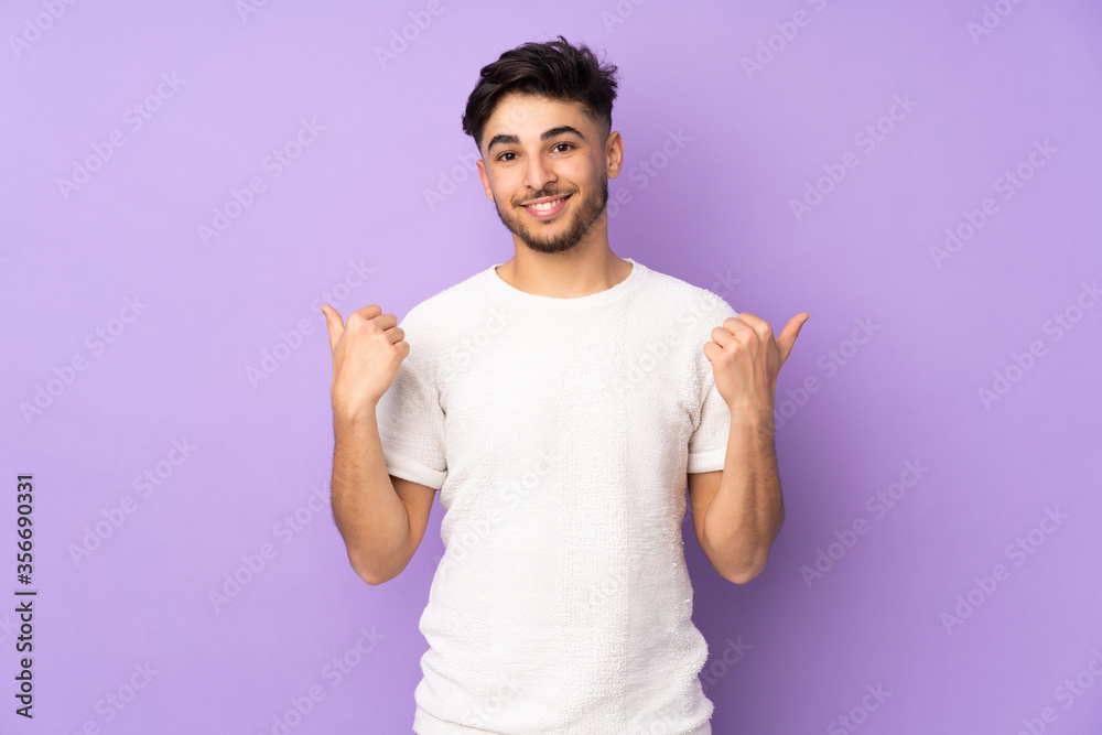 Arabian handsome man over isolated background with thumbs up gesture and smiling