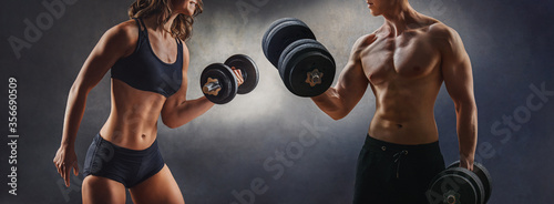 smiling woman an man with dumbbell - successful fitness studio concept