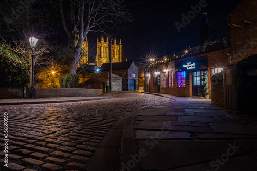 Ancient streets of historical city Lincoln, fantastic adventure travel destination or holiday vacation to view picturesque scenery day or night, sunrise or sunset © Andy