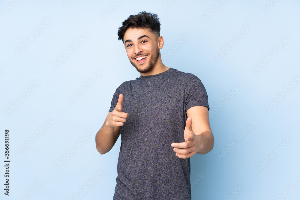 Arabian handsome man over isolated background pointing to the front and smiling Arabian handsome man over isolated background pointing to the front and smiling
