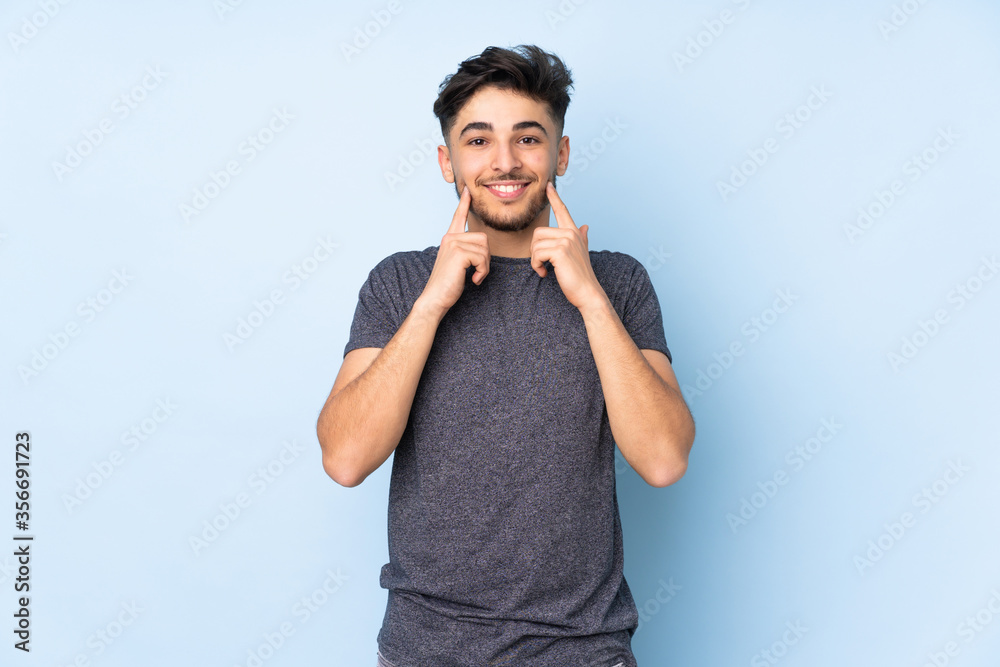 Arabian handsome man over isolated background smiling with a happy and pleasant expression