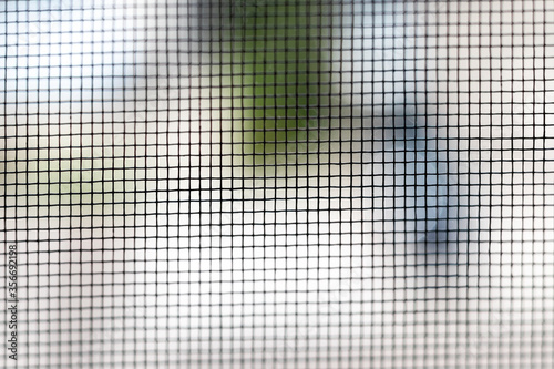 Mosquito net on the window closeup. Protection of the house from small insects. Background. Selective focus