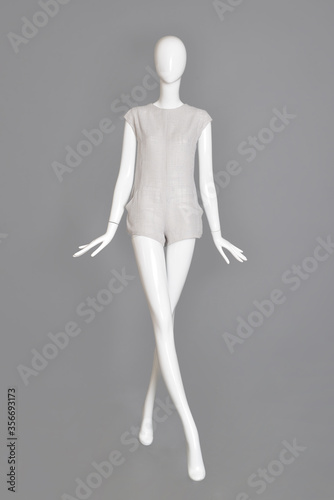 lifeless mannequin with blue beach dress isolated grey background studio