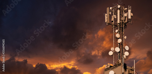 5G network transmitters on the roof of a skyscraper on a background of dramatic sky. photo