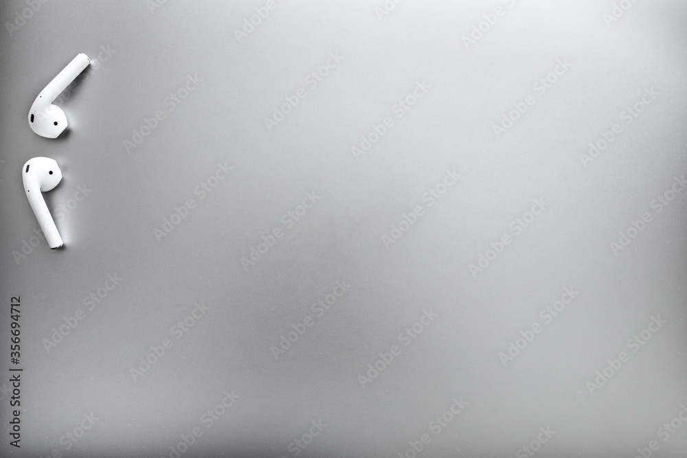 Top view of white headphones on a gray background. Space for copy. Top view of white headphones on a gray background. Space for copy.