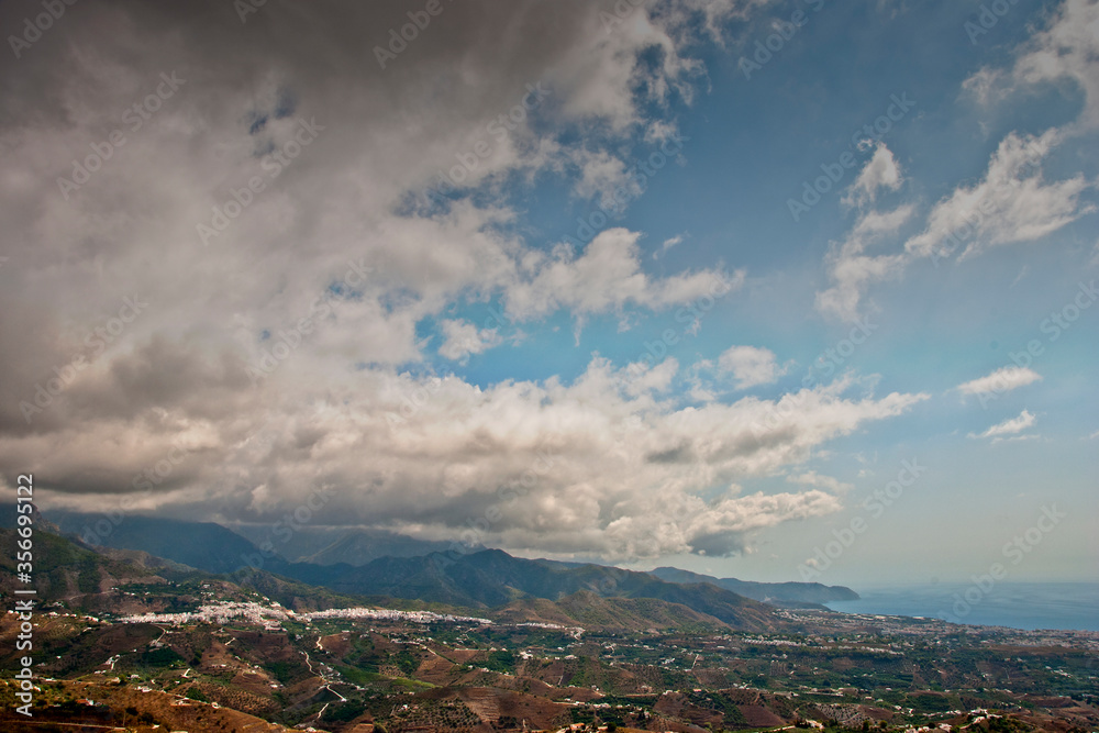 Storm clouds surrounding Nerja and The Moorish village of Frigiliana nestling in the mountains, Costa del Sol, Andalucia, Spain