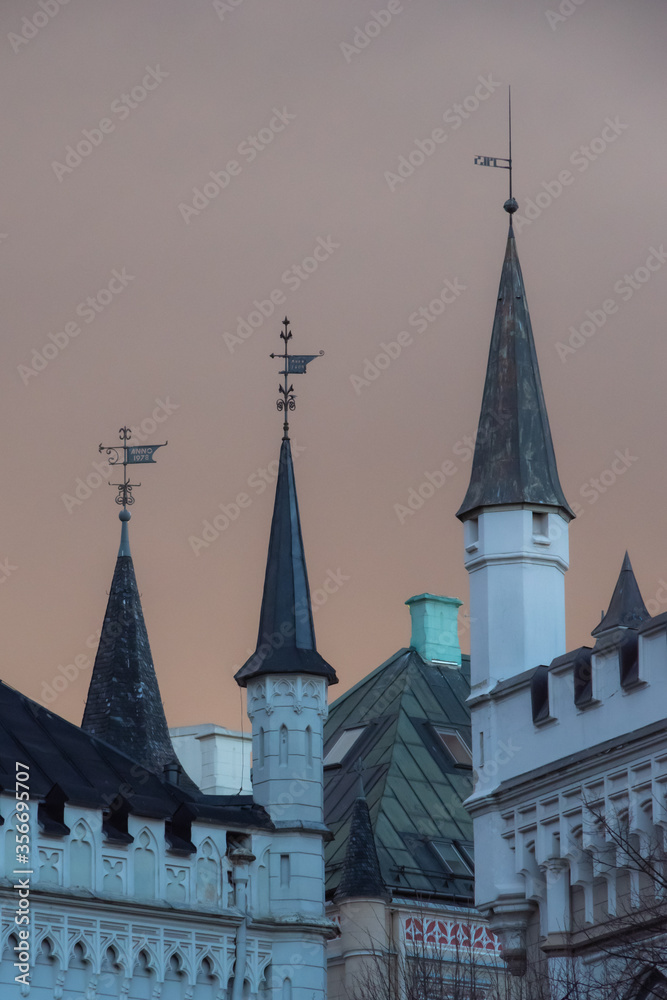 View to the towers of the Small Guild and the Great Guild in the Old Town of Riga under dramatic evening clouds
