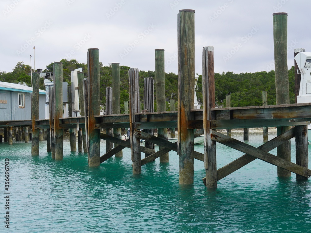 A wooden pier or dock wait for visiting boats to one of the islands in the Exuma Cays in the Bahamas