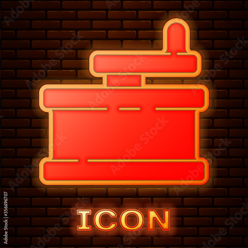 Glowing neon Manual grinder icon isolated on brick wall background. Vector Illustration