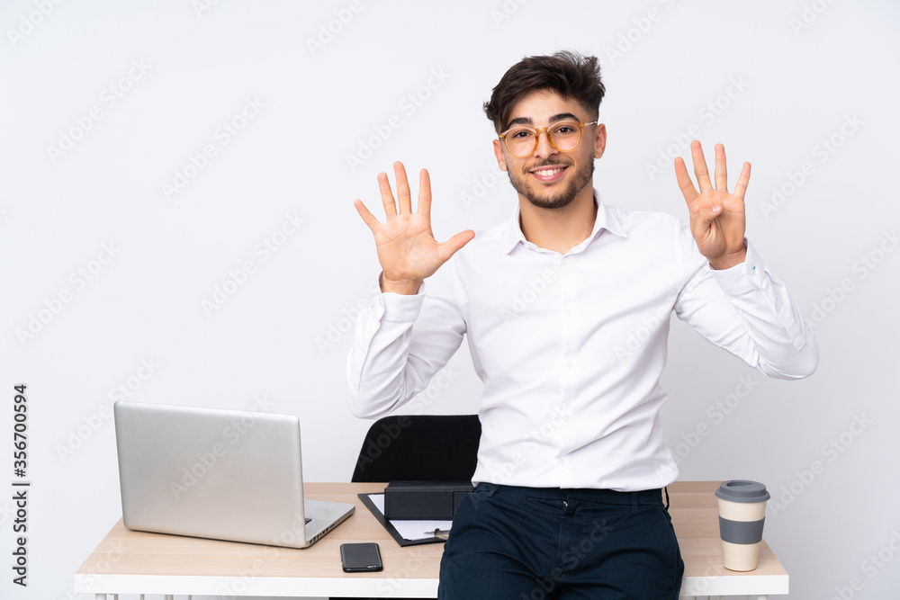 Arabian man in a office isolated on white background counting nine with fingers Arabian man in a office isolated on white background counting nine with fingers