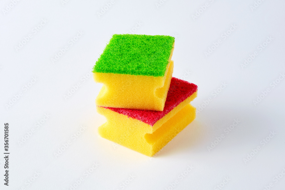 Two kitchen sponges with colorful scouring pads on white background Two kitchen sponges with colorful scouring pads on white background