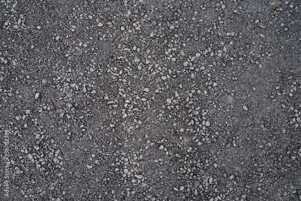 Fragment of road with asphalt surface.