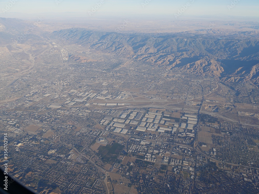 Aerial view of the outskirts of Los Angeles seen from an airplane window.