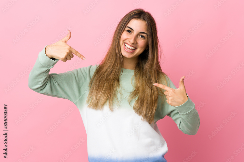 Young woman over isolated pink background proud and self-satisfied Young woman over isolated pink background proud and self-satisfied