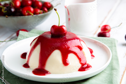 Italian panna cotta dessert with cherry coulis photo