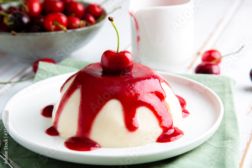 Italian panna cotta dessert with cherry coulis