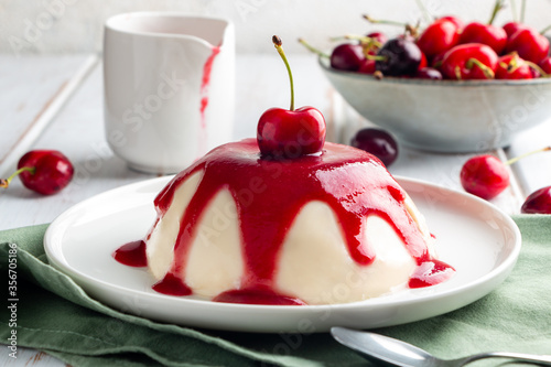  Close up of Italian panna cotta dessert with cherry coulis photo