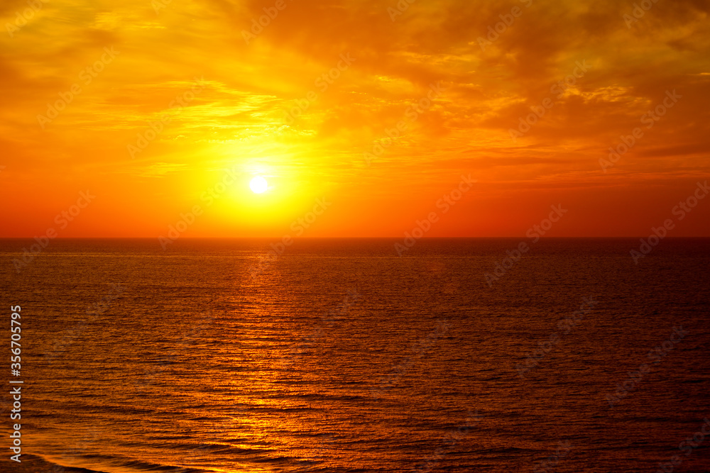 Fantastic ocean and sunset sky in red colors.