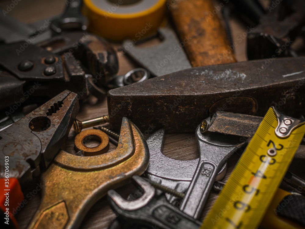 Building and measuring tools. Set of tools over a wood panel. Construction Tools With Blueprint On Wooden Desk