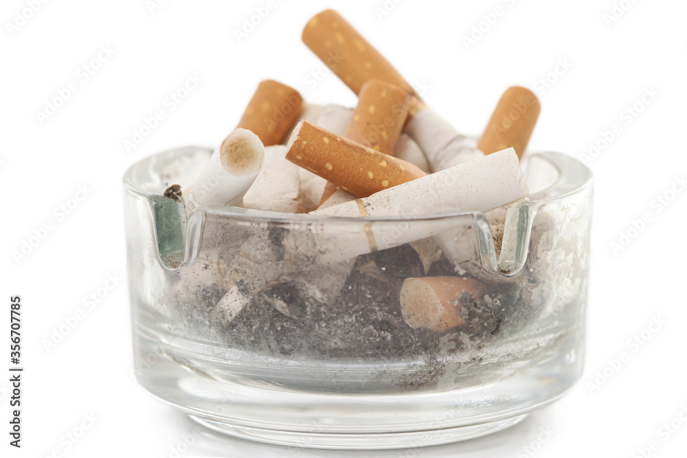 Bunch used cigarettes inside ashtray isolated white background Bunch used cigarettes inside ashtray isolated white background