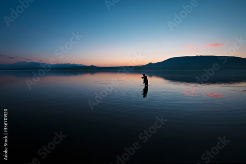 Lone fisherman on the lake. Russia. Ural.