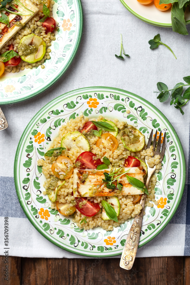 Ptitim or Israeli pasta with tomatoes and halloumi