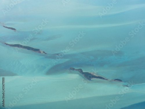 Beautifully shaped islets of the Exuma Cays Bahamas seen from an airplane window. © raksyBH
