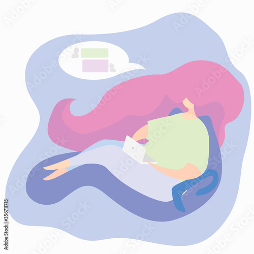 The girl relaxes while sitting at a laptop and chatting with friends in instant messengers.