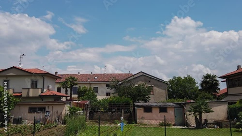 Wallpaper Mural Timelapse Clouds Over the Houses at Sunny Day Torontodigital.ca