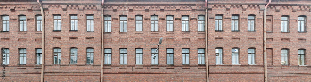 Facade of an old brick residential building after reconstruction. Panorama.