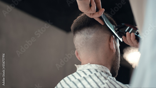 Men's hairstyling and haircutting in a barber shop or hair salon.