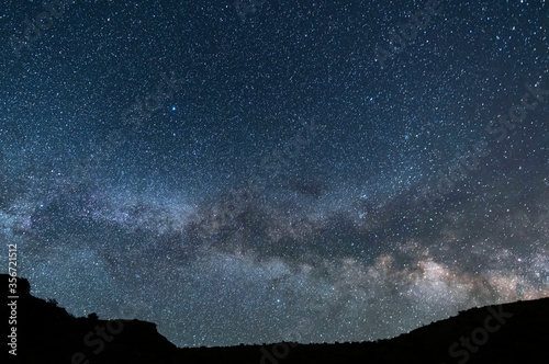 Beautiful starry sky with bright milky way galaxy. Night landscape. Astronomical background. © Inga Av