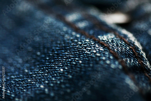 Jeans denim texture close up , focus only one point , soft blured background wallpaper