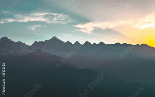 Mountain silhouette of Panchchuli peaks during morning sunrise in great Himalayan mountain chain range from Khalia Top at small hamlet Munsiyari, Kumaon region, Uttarakhand, India. © anjali04
