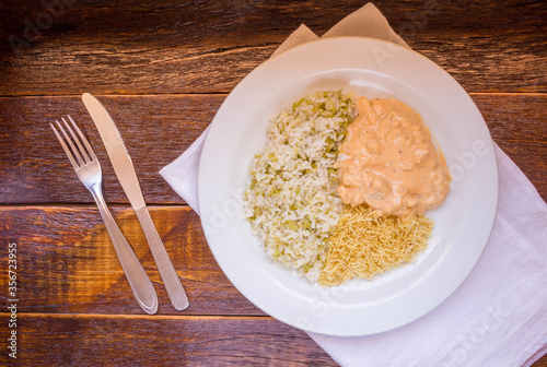 Delicious healthy food with chicken strogonoff with rice and french fries on dish. View from the top
