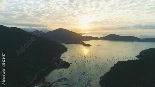 Drone Aerial Shot of Sununga at ubatuba Brazil. Sunset on Marina and beautifil forest landscape near the ocean
 photo