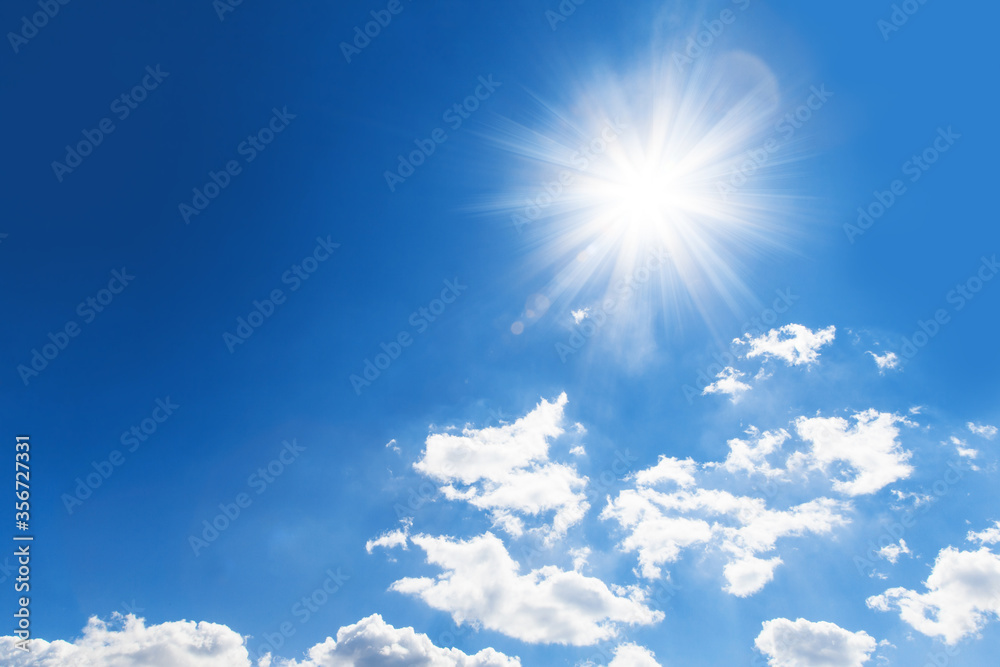 shiny sun against blue cloudy sky with copy space. Abstract background shiny sun against blue cloudy sky with copy space. Abstract background