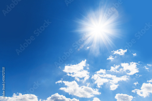 shiny sun against blue cloudy sky with copy space. Abstract background 