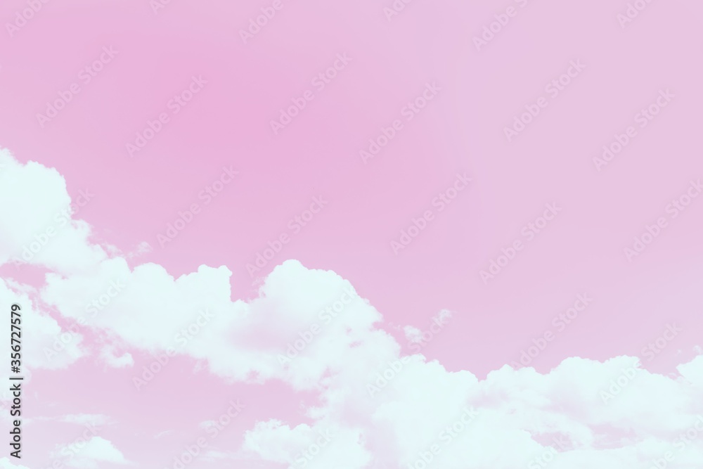 Scenic pink sky background with fluffy white clouds. Copy space