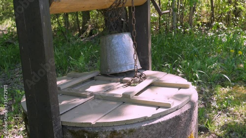 A wooden cover on the deep old well in the village in Estonia