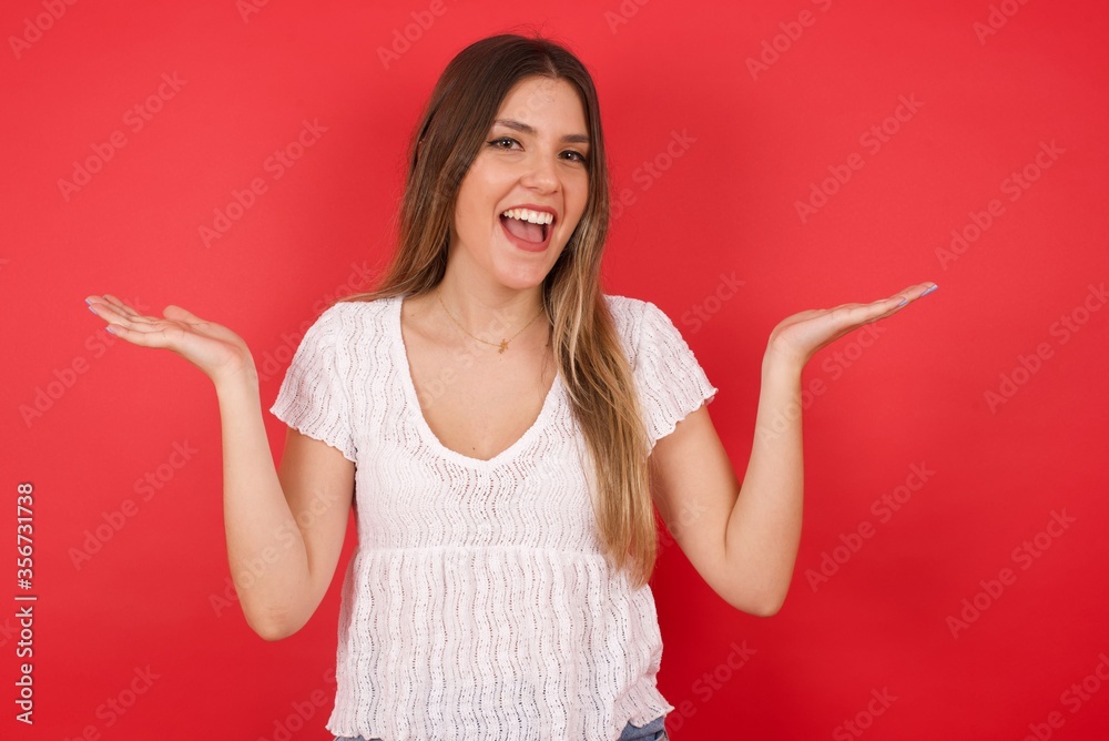 Achievement, success concept. Cheerful female raising her hands up, having eyes full of happiness rejoicing her great achievements. Attractive caucasian female dressed formally. Achievement, success concept. Cheerful female raising her hands up, having eyes full of happiness rejoicing her great achievements. Attractive caucasian female dressed formally.