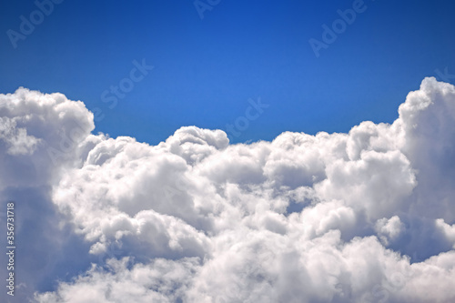 Beautiful blue sky and white fluffy clouds, view sky from an airplane