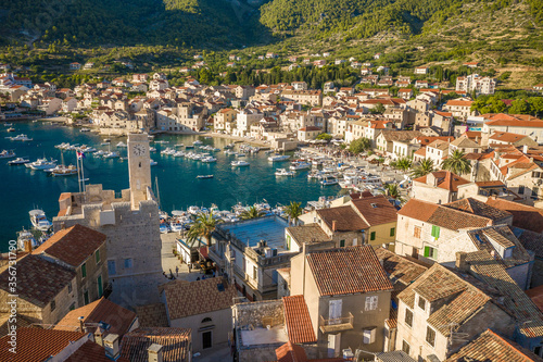 Aerial view of a jetty surrounded by houses on sunny day in Komiza, Croatia photo