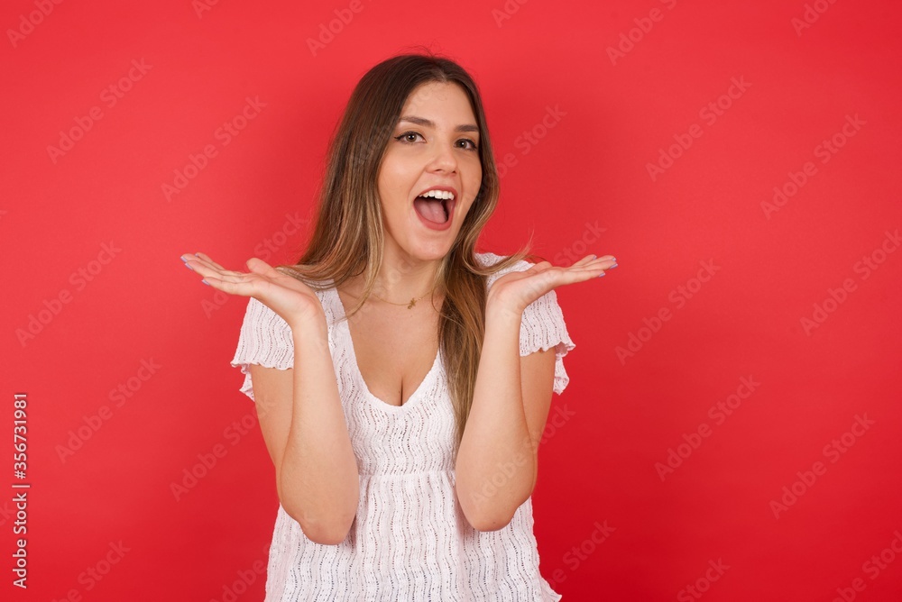 Fototapeta premium Surprise concept. Portrait of astonished beautiful girl looking surprised in full disbelief wide open mouth with hands near face with braided hair. Positive emotion facial expression body language.