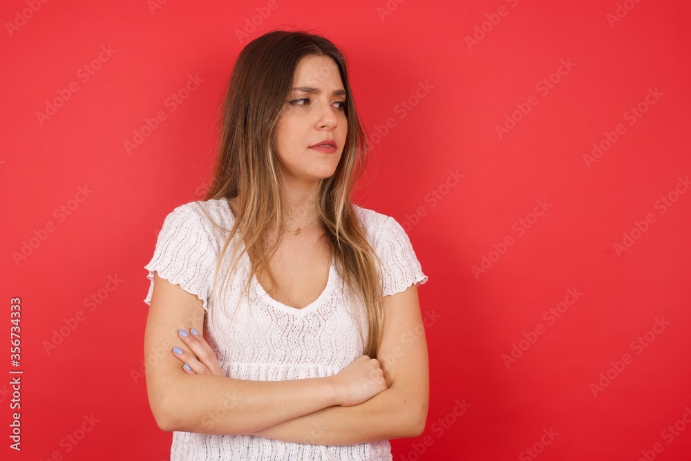 Closeup portrait displeased pissed off angry grumpy pessimistic woman with bad attitude, arms crossed looking sideways. Negative human emotion facial expression feelings Closeup portrait displeased pissed off angry grumpy pessimistic woman with bad attitude, arms crossed looking sideways. Negative human emotion facial expression feelings