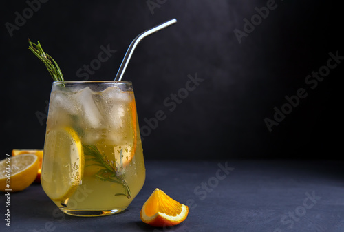 Soft drink with lemon and orange on a dark background photo