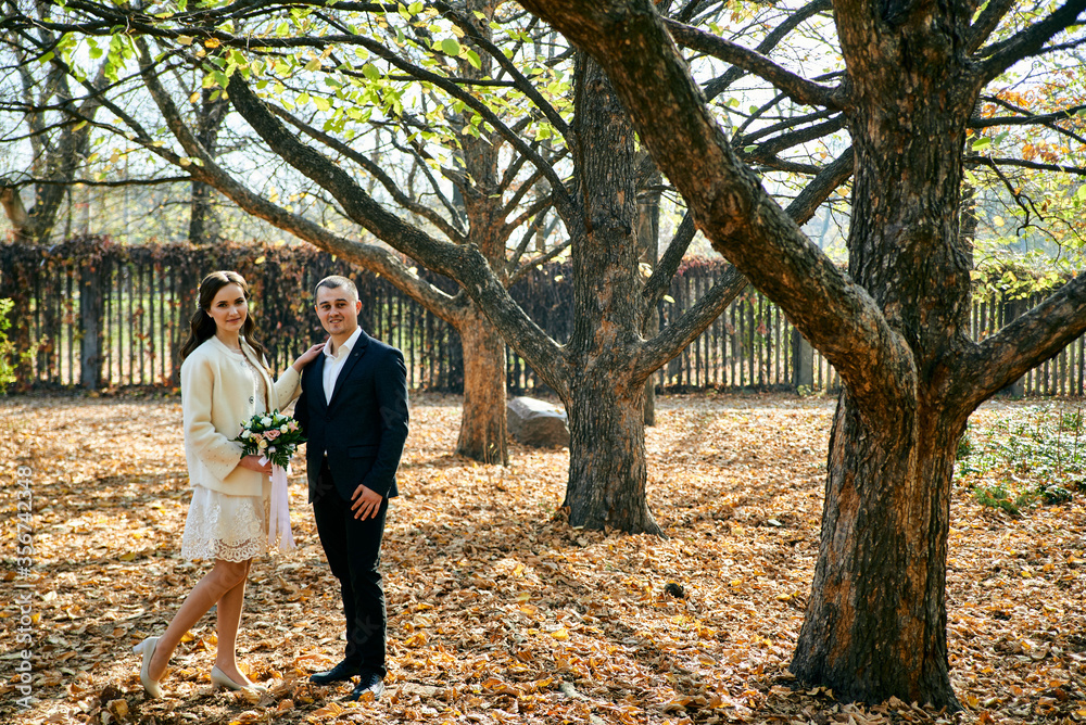 Fototapeta premium Young male and woman just married. Concept of happy family. Modern family outdoor.