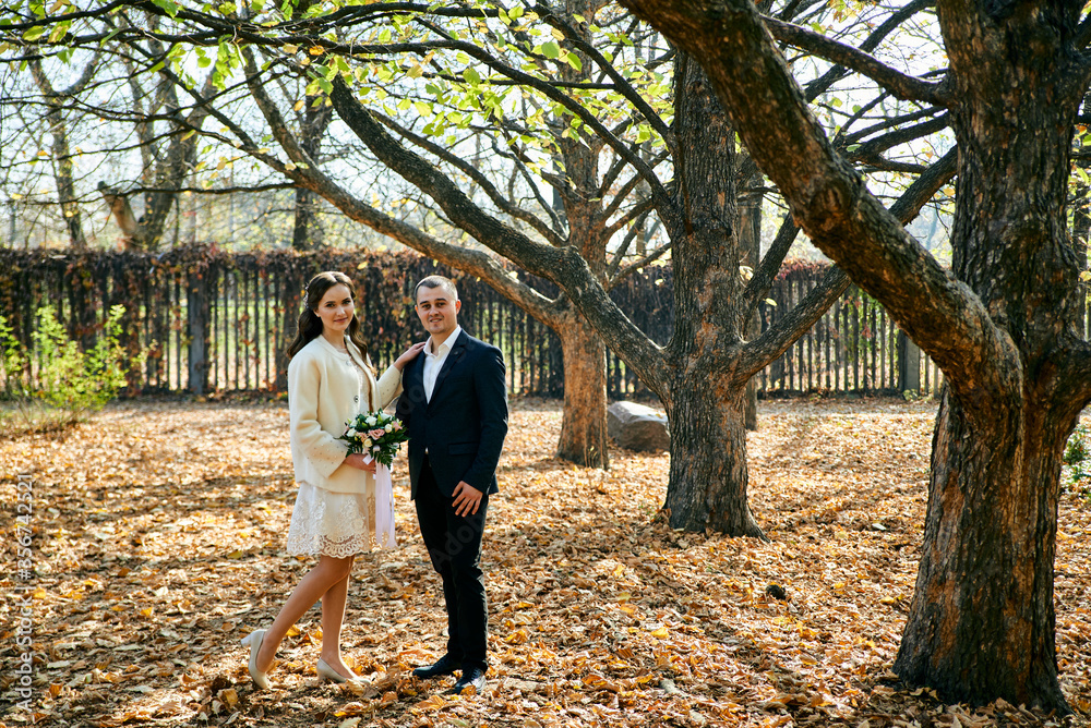 Fototapeta premium Young male and woman just married. Concept of happy family. Modern family outdoor.