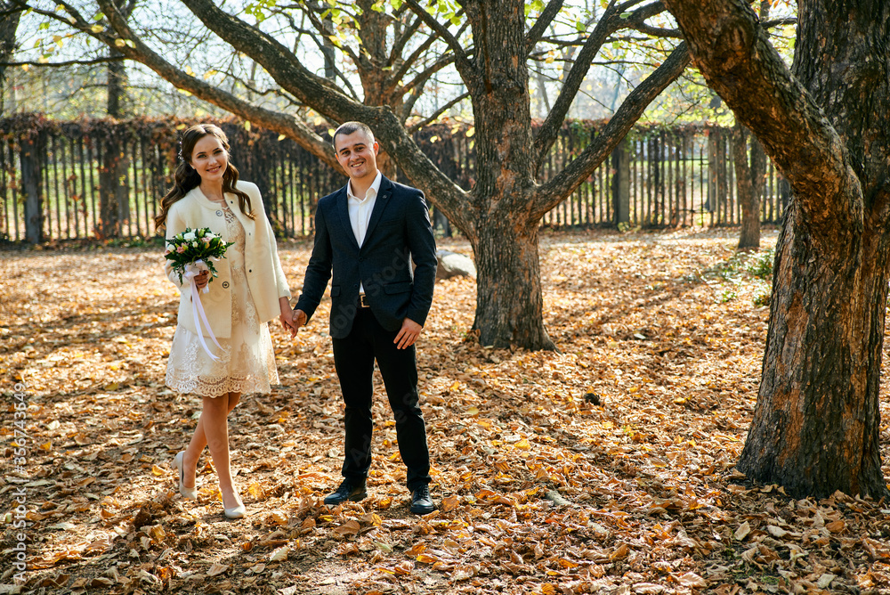 Fototapeta premium Young male and woman just married. Concept of happy family. Modern family outdoor.